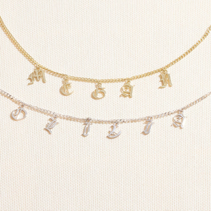Personalized name necklace featuring Gothic Old English design with Dangle letters in gold and silver chains.