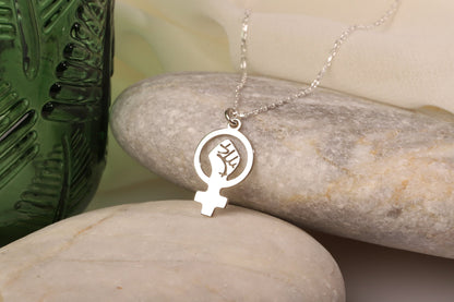 A silver necklace with a Venus symbol pendant