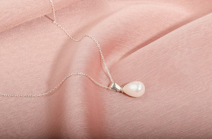  a dainty freshwater pearl necklace with a gold accent
