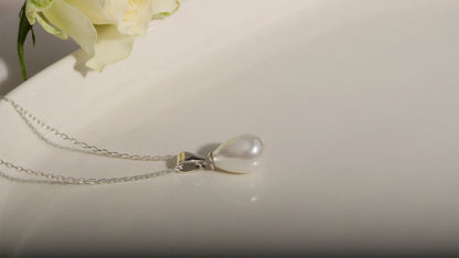  a dainty freshwater pearl necklace with a gold accent