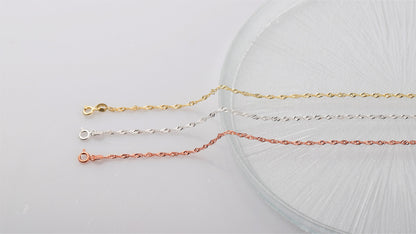 A close-up image of 3  Singapore chain necklaces in gold silver and rose on white background