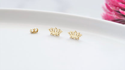 a 14K gold dainty lotus flower stud earring in a white background.