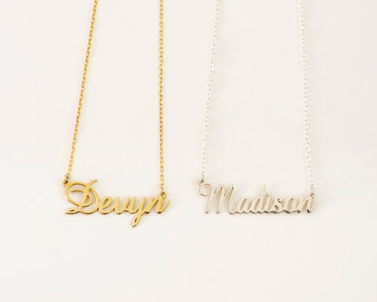 Two personalized couple name necklaces, one in gold and one in silver, each with a different name written in a different font.