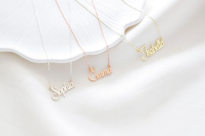 A close-up image of 3 name necklaces in gpld silver and rose