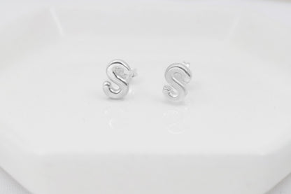 A close-up image of a silver initial stud earring, on a white background.