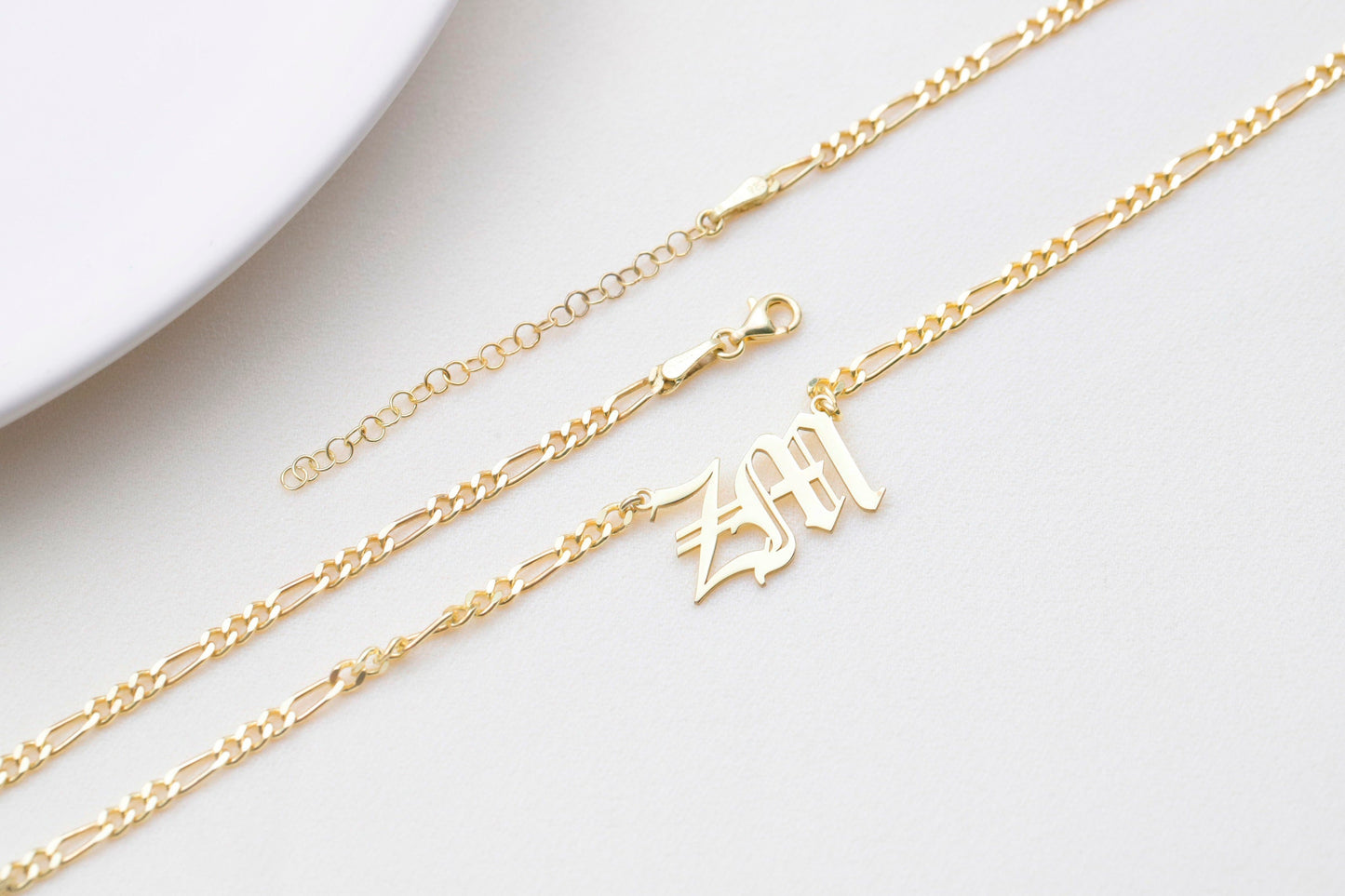 A full view of a gold-filled necklace with a 'ZM' charm, laid out to show the chain, lobster clasp, and extender. A product by SilverGoldandRose.com.