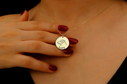 Gold necklace with a pendant on a person's neck