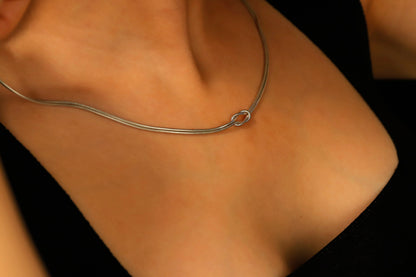 a silver snake chain necklaces on a model