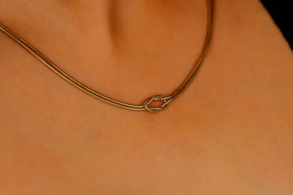 a gold snake chain necklaces on a model