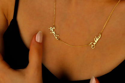 A close-up image of a custom two-name necklace made of 14K gold filled, featuring the names in a cursive script.