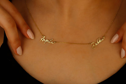 A close-up image of a custom two-name necklace made of 14K gold filled, featuring the names in a cursive script.