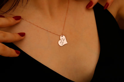 Heart-shaped pendant necklace on a person's neck with a close-up view.