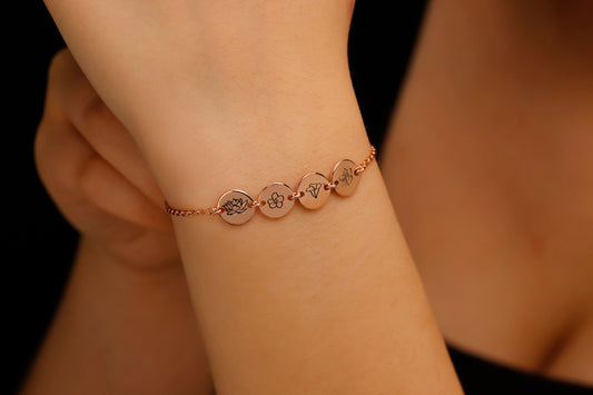 Rose gold bracelet on a wrist with a blurred background