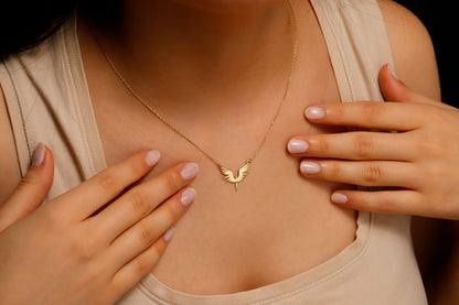 Necklace with a bird-shaped pendant worn by a person
