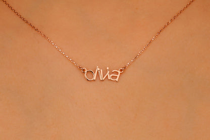 Rose gold 'Olivia' necklace on a peach background