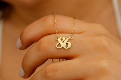 A close-up image of a woman wearing a personalized necklace with a number '86' in gold-tone on a silver chain.