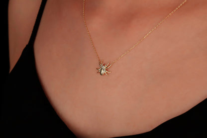 A close-up image of a person wearing a 3D spider necklace made of 925 sterling silver.