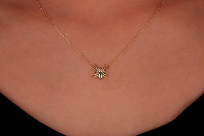 A close-up image of a person wearing a 3D spider necklace made of 925 sterling silver.