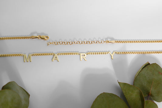 A sterling silver initial name necklace with gold finish