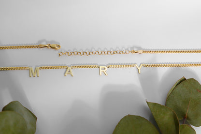 A sterling silver initial name necklace with gold finish