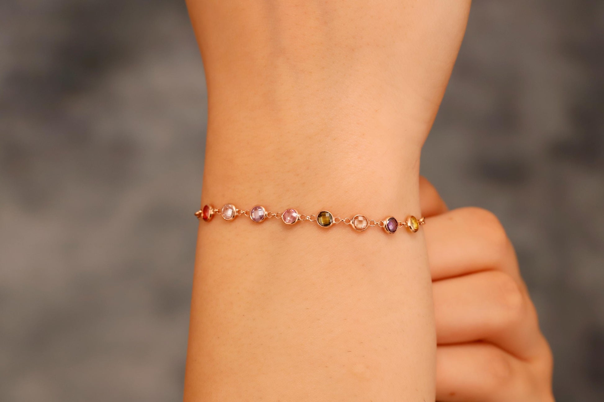Multicolored beaded bracelet on a wrist with a blurred background