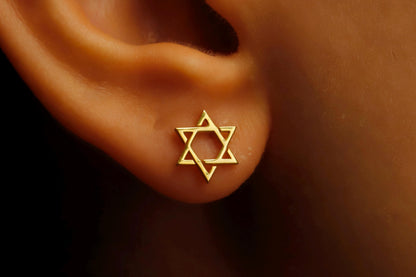 Close-up image of a person wearing a gold-filled David Star earring.