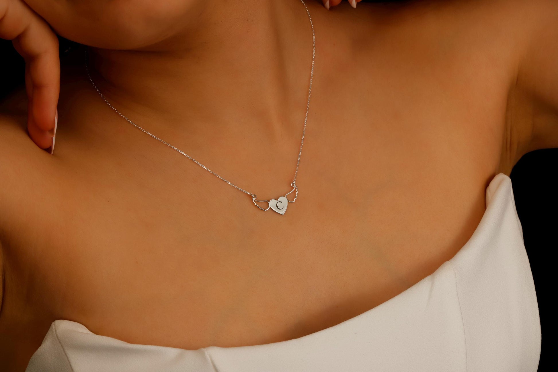 Necklace with a heart-shaped pendant on a person's neck