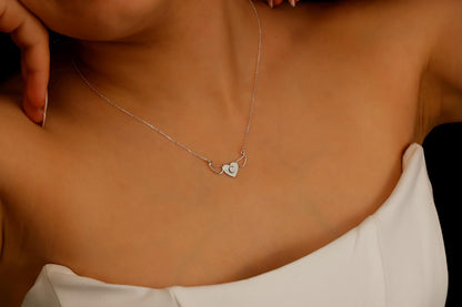 Necklace with a heart-shaped pendant on a person's neck