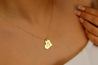 Gold necklace with a heart-shaped pendant on a person's neck