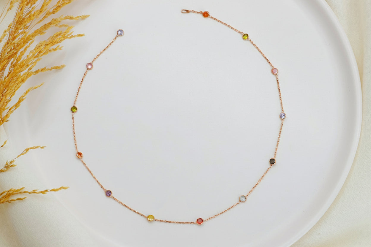 Delicate necklace with small beads on a white plate with a natural background