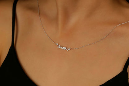Necklace with 'To You Only' pendant on a person wearing a black top.