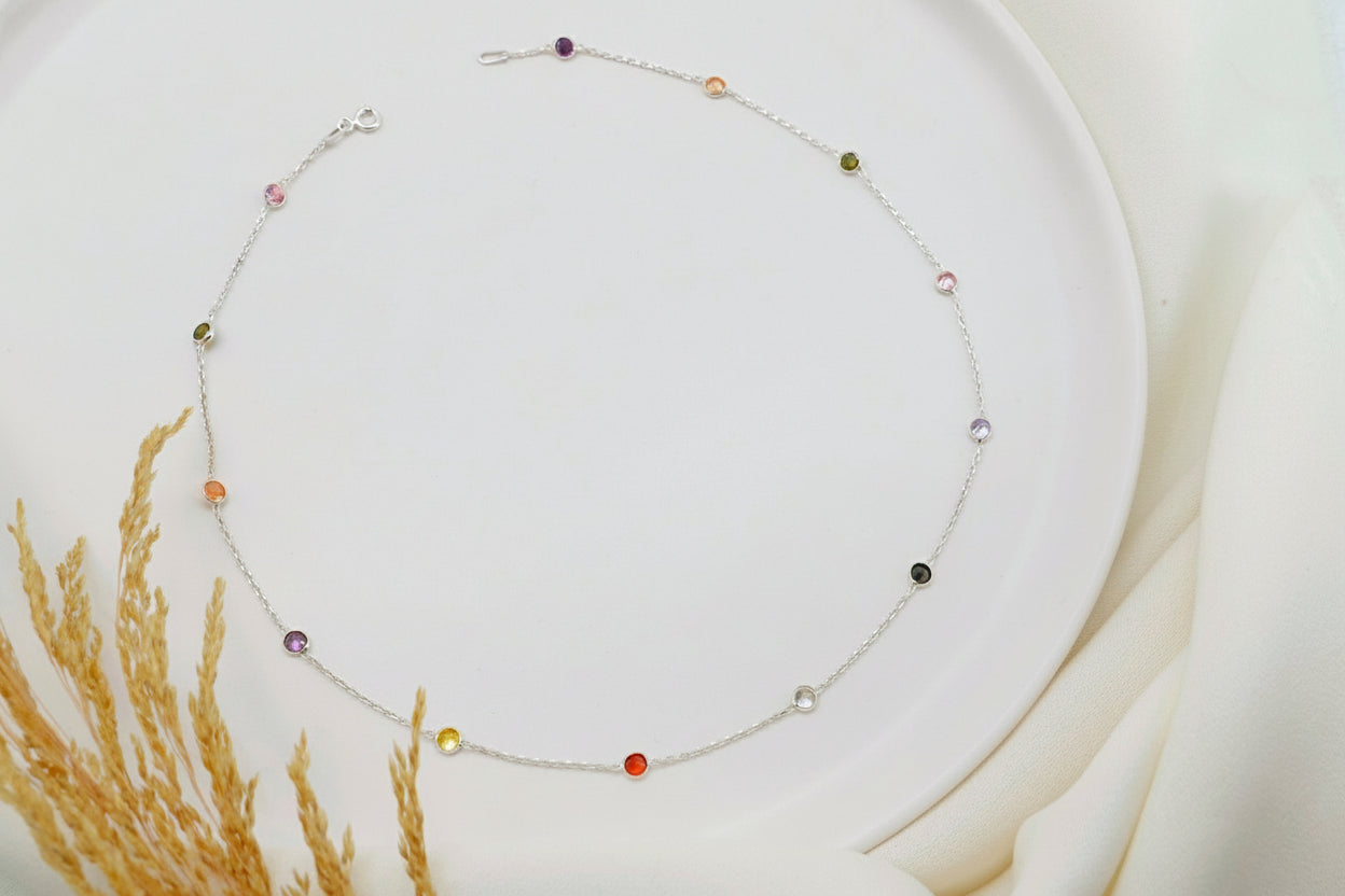 Necklace with colorful beads on a white plate with a soft background