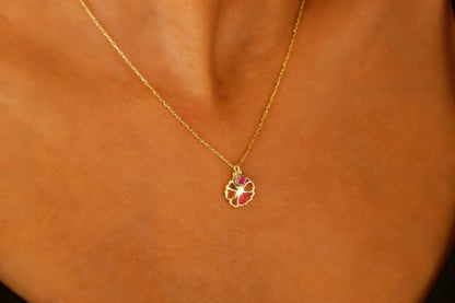 Gold necklace with a pendant on a person's neck