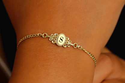 a custom vintage style bracelets in gold, with an engraved letter.