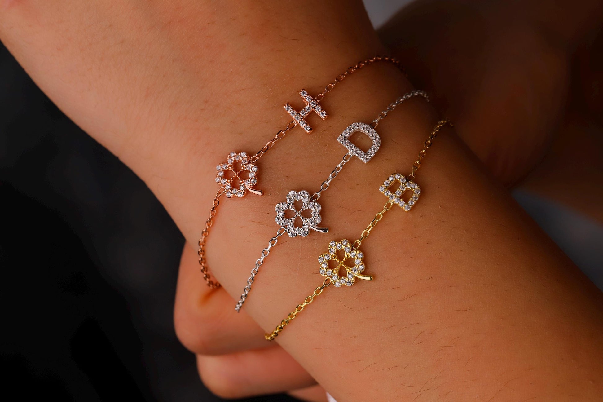 Three floral-patterned bracelets on a wrist against a neutral background