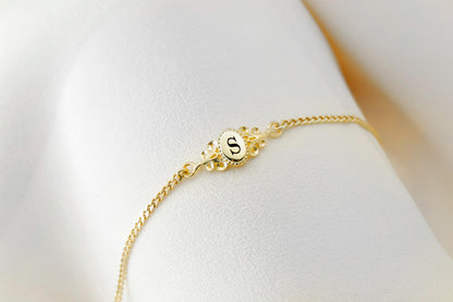 a custom vintage style bracelets in gold, with an engraved letter.