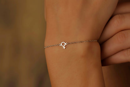 Bracelet with a small circular design on a wrist against a blurred background