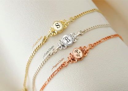 A collection of custom vintage style bracelets in gold, silver, and rose gold colors, each featuring an engraved letter.