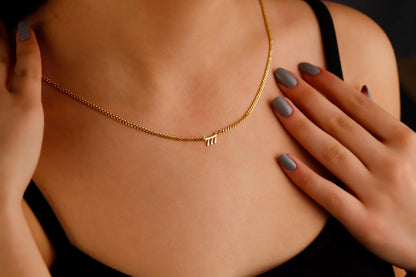 A close-up image of a woman wearing a sterling silver necklace with the number 777 in a small, elegant font, positioned on her collarbone.