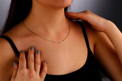 A close-up image of a woman wearing a sterling silver necklace with the number 333 in a small, elegant font, positioned on her collarbone.