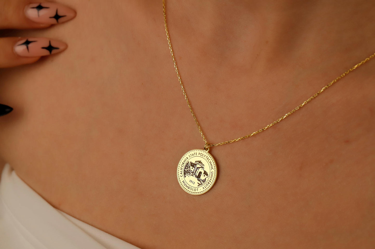 Gold necklace with a round pendant on a person's neck