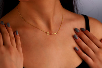 A gold name necklace with the name 'Cessica' displayed on a model.