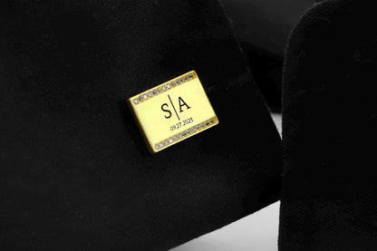 Gold name cufflink with initials 'S&A' on a black background