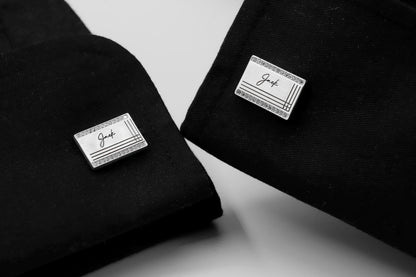 Two black shirts with 'Jack' branded cufflnks on a white background