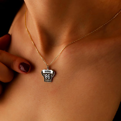 Necklace with a pendant on a person's neck against a dark background