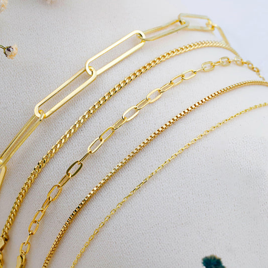 Set of gold chains on a light background