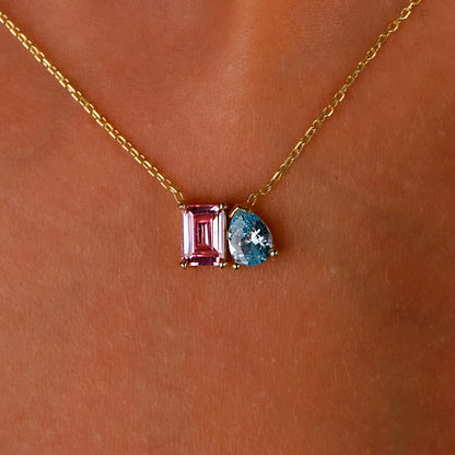 Necklace with pink and blue gemstones on a skin background