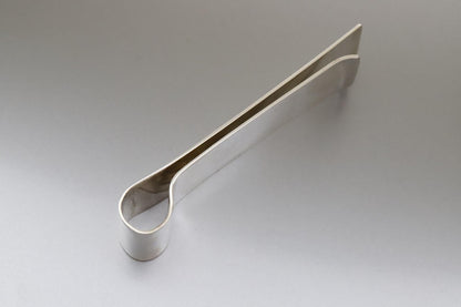 Metallic letter opener on a gray background