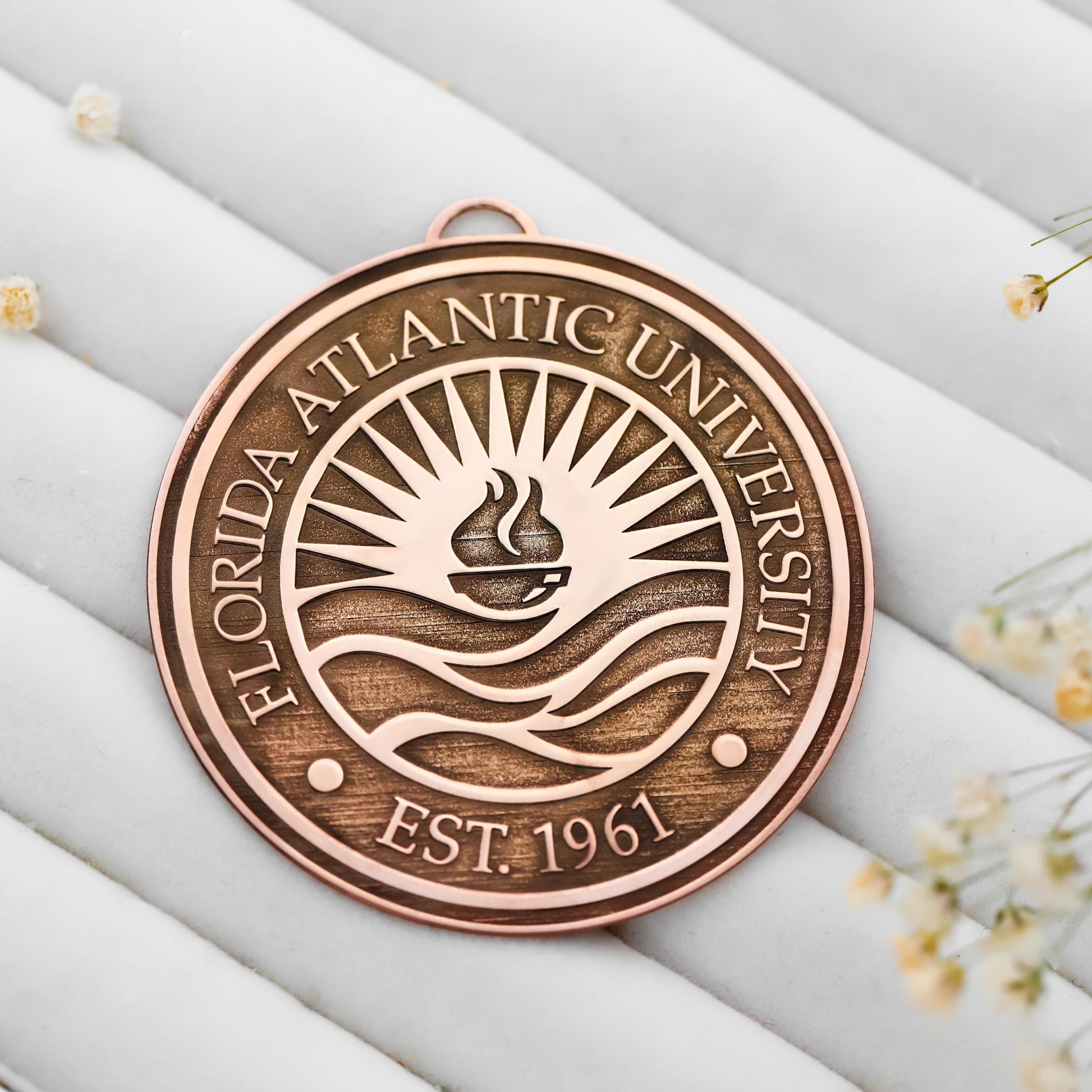 Bronze plaque with Florida Atlantic University logo and text on a light background