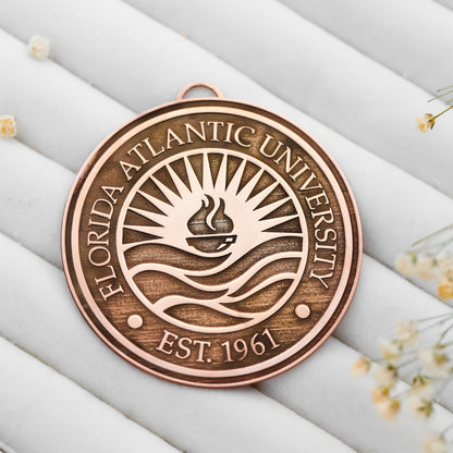 Bronze plaque with Florida Atlantic University logo and text on a light background